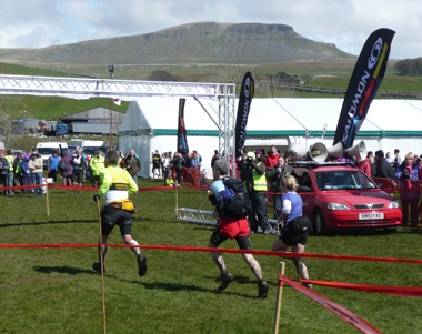 Runners race to the finish of the 58th 3 Peaks Fell Race