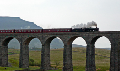 A steam train crosses Ribblehead Viaduct
