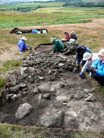 Trench G107 is opened on Stanbury Hill, found to contain an oval stone structure.
