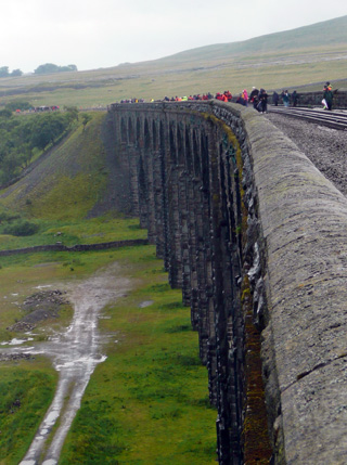A group cross Ribblehead Viaduct